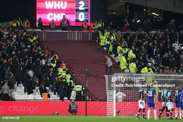 Chelsea fan breaks through the police line and confronts the West Ham fans during the EFL Cup 4th Round match between West Ham United and Chelsea at...