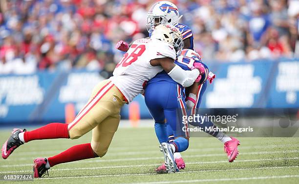 Eli Harold of the San Francisco 49ers tackles Robert Woods of the Buffalo Bills during the game at New Era Field on October 16, 2016 in Orchard Park,...