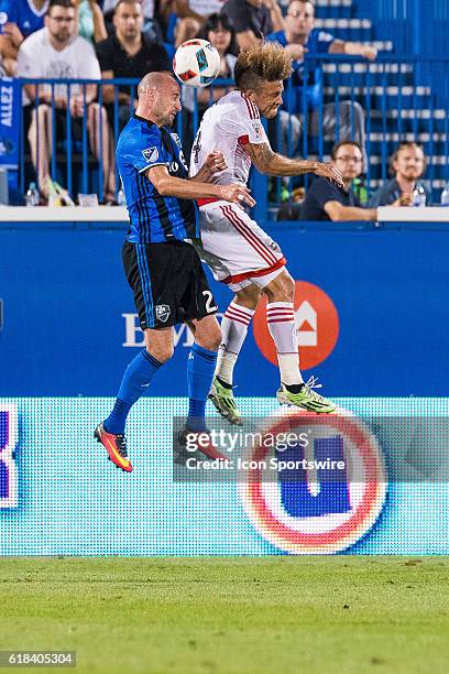 Impact Laurent Ciman and DC United Nick DeLeon jump in the air to hit the ball with their head during the DC United game versus the Montreal Impact...