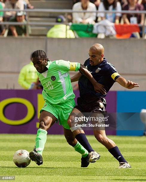 Juan Veron of Argentina tries to tackle Jay Jay Okocha of Nigeria during the Group F match of the World Cup Group Stage played at the...