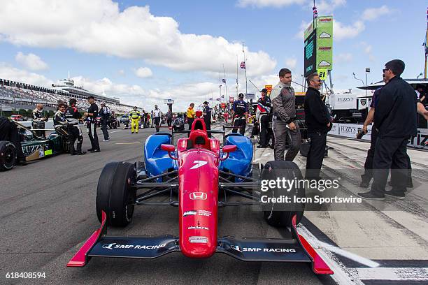 The SMP Racing Schmidt Peterson Honda driven by pole sitter Mikhail Aleshin sits on the grid prior to the start of the ABC Supply 500 at Pocono...