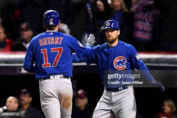 Kris Bryant of the Chicago Cubs celebrates with Ben Zobrist after scoring a run during the first inning against the Cleveland Indians in Game Two of...