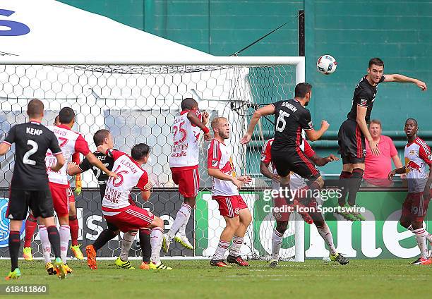 United forward Patrick Mullins heads the ball in the Red Bulls goal area during a MLS match at RFK Stadium, in Washington D.C. DC United tied the New...