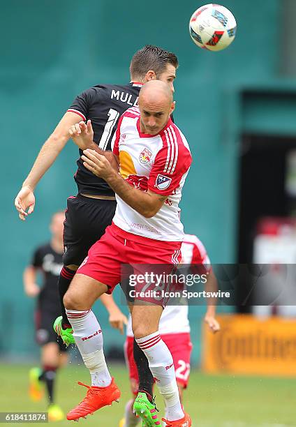 United forward Patrick Mullins flicks a header past New York Red Bulls defender Aurelien Collin during a MLS match at RFK Stadium, in Washington D.C....