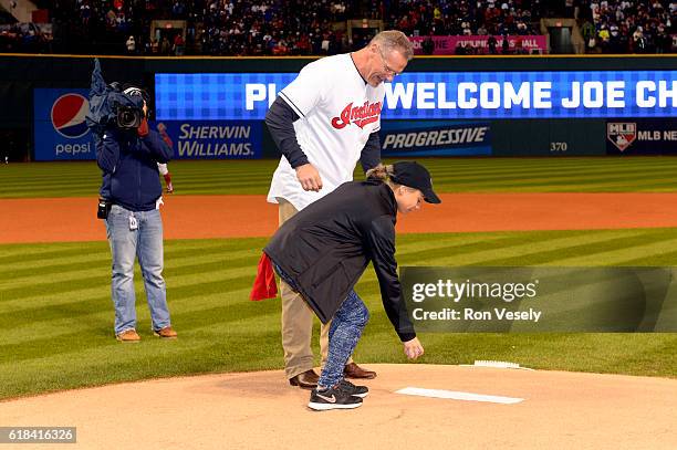 Cleveland Boys & Girls Clubs of America member Zaylianny Mojica Mendez delivers the first ball with former Cleveland Indians player Joe Charboneau...