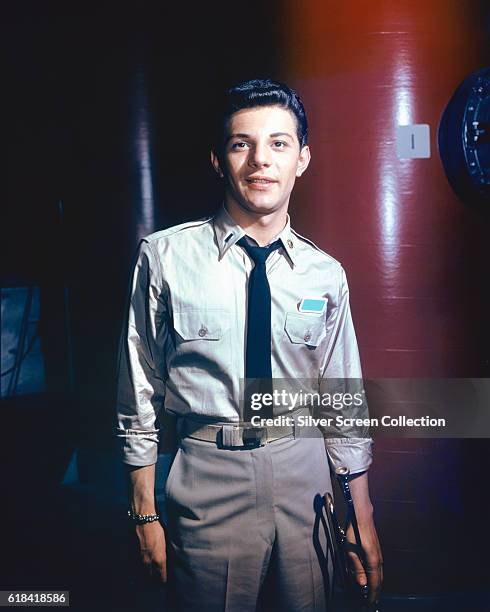 American actor, singer and musician Frankie Avalon holding his trumpet on the set of the 20th Century Fox science fiction film 'Voyage to the Bottom...