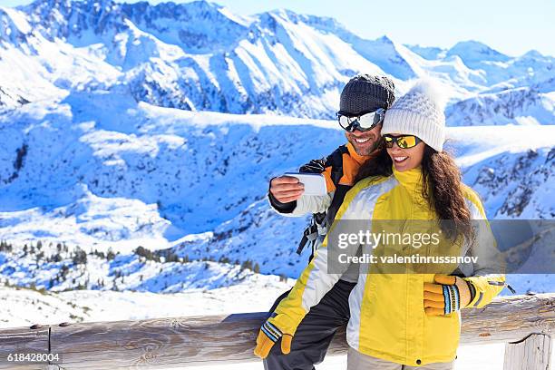 cheerful young people making selfie on snow mountain - bansko stockfoto's en -beelden