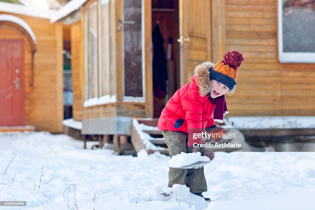 Child with shovel in winter