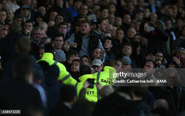 Safety stewards separate the fans during the EFL Cup fourth round match between West Ham and Chelsea at The London Stadium on October 26, 2016 in...