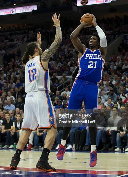 Joel Embiid of the Philadelphia 76ers takes a shot against Steven Adams of the Oklahoma City Thunder in the second quarter at Wells Fargo Center on...