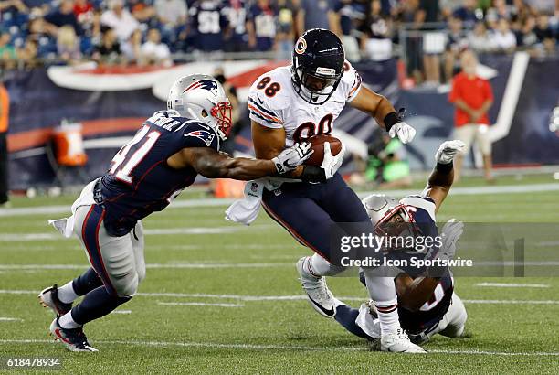 New England Patriots safety Cedric Thompson tries to stop Chicago Bears tight end Rob Housler with New England Patriots defensive back Jordan...
