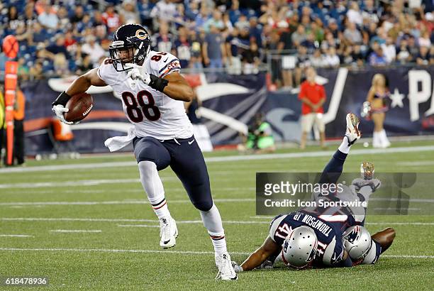 Chicago Bears tight end Rob Housler breaks away as New England Patriots safety Cedric Thompson crashes into teammate defensive back Jordan Richards ....