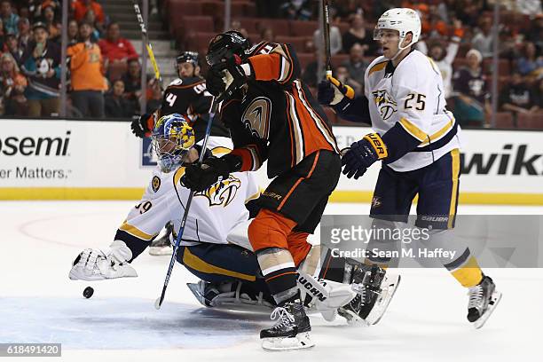 Cam Fowler of the Anaheim Ducks battles Marek Mazanec of the Nashville Predators for a loose puck during the third period of a game at Honda Center...