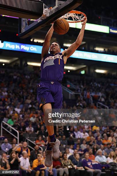 Devin Booker of the Phoenix Suns slam dunks the ball against the Sacramento Kings during the second half of the NBA game at Talking Stick Resort...