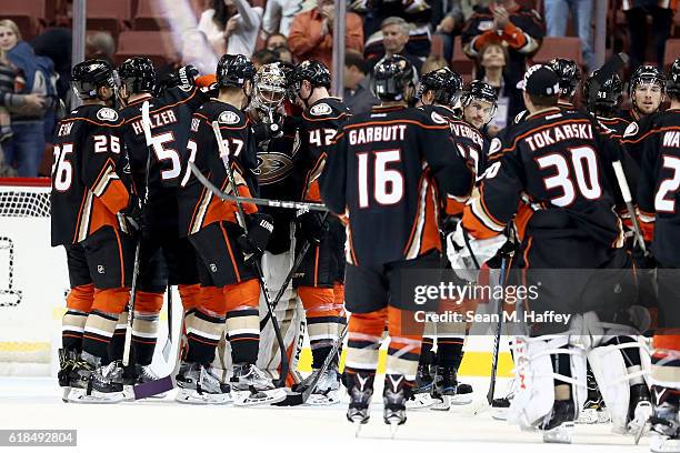 Emerson Etem, Korbinian Holzer, Ryan Garbutt, Hampus Lindholm and Nick Ritchie of the Anaheim Ducks congratulate John Gibson after defeating the...