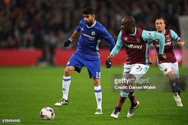 Diego Costa of Chelsea is challenged by Angelo Ogbonna of West Ham United during the EFL Cup fourth round match between West Ham United and Chelsea...