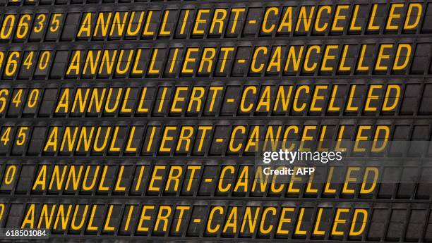 An information board displays cancelled flights at the airport Stuttgart, southern Germany, on October 27, 2016. - 380 of 555 flights of budget...