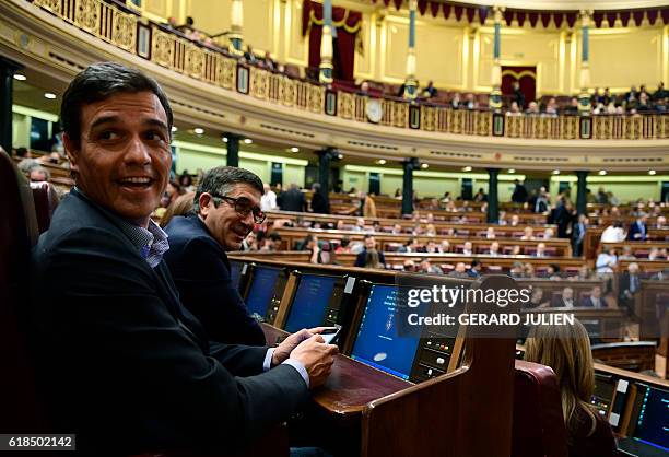 Former leader of the Spanish Socialist Party , Pedro Sanchez and former president of the parliament, Socialist Patxi Lopez , smile as they sit on...