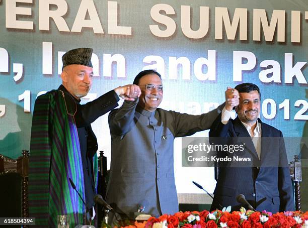 Pakistan - Afghan President Hamid Karzai, Pakistani President Asif Zardari and Iranian President Mahmoud Ahmadinejad shake hands after a press...