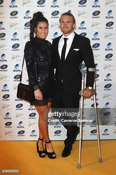 Australian Sevens player Charlotte Caslick poses with partner and Australian Sevens player Lewis Holland arrive at the 2016 John Eales Medal at Royal...