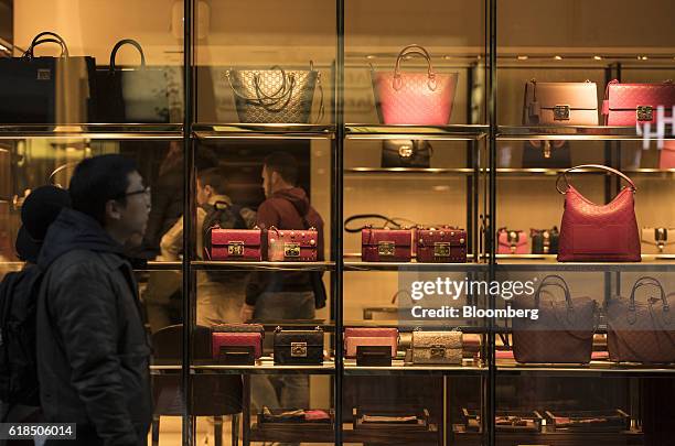 Luxury leather handbags sit in the window display of a Gucci high-end goods boutique, operated by Kering SA, in Frankfurt, Germany, on Wednesday,...