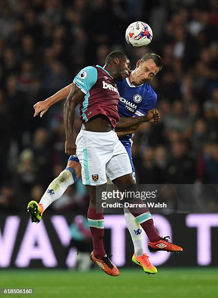 Michail Antonio of West Ham United and John Terry of Chelsea compete for a header during the EFL Cup fourth round match between West Ham United and...