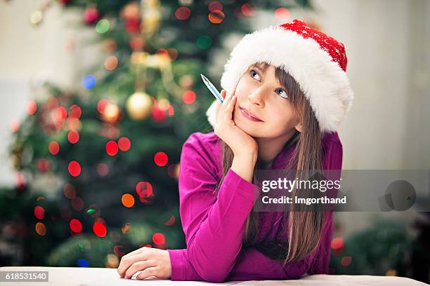 christmas portrait of a little girl writing letter to santa - child writing letter to santa stock pictures, royalty-free photos & images