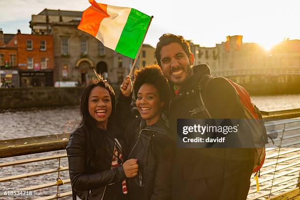 tourists taking selfies on vacation in dublin ireland - woman irish flag stock pictures, royalty-free photos & images