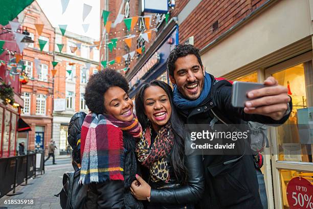 tourists taking selfies on vacation in dublin ireland - dublin imagens e fotografias de stock