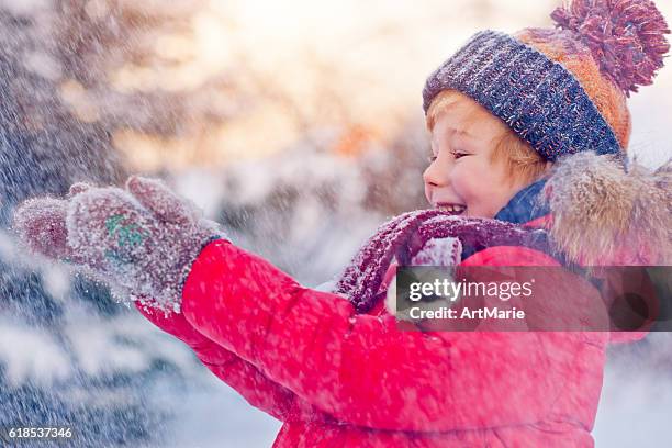 child in winter - catching snowflakes stock pictures, royalty-free photos & images