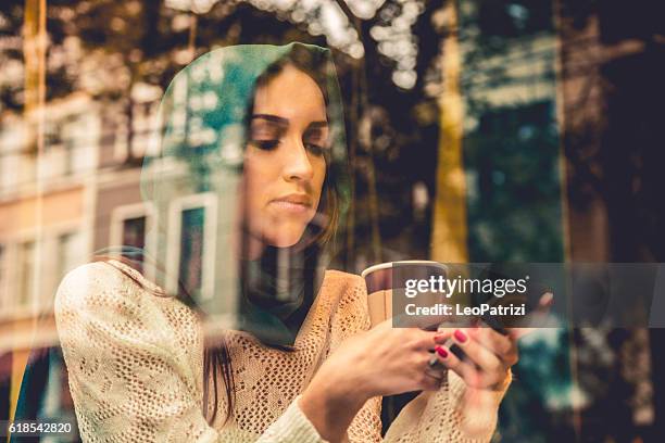 portrait of a woman on the window of a cafe - west asia stock pictures, royalty-free photos & images