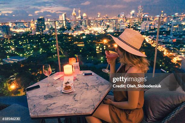 woman drinking in rooftop bar in bangkok - rooftop view stock pictures, royalty-free photos & images