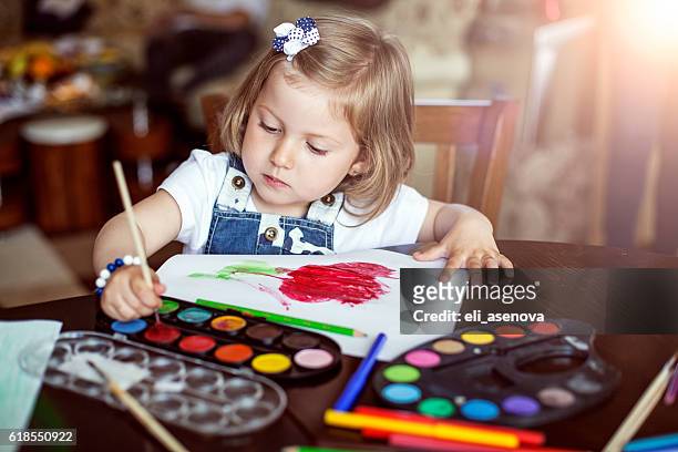 little girl painting - baby paint stock pictures, royalty-free photos & images