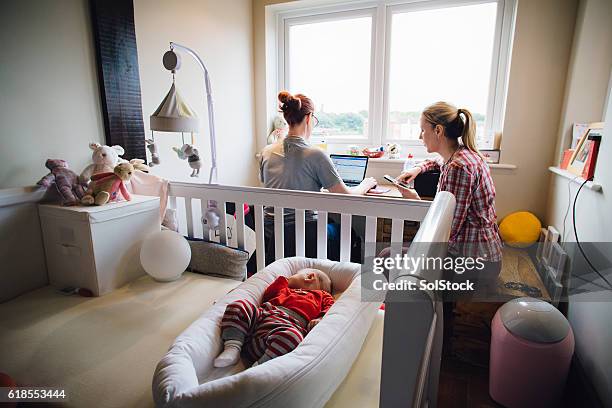 multitasking mothers - lesbian bed stock pictures, royalty-free photos & images