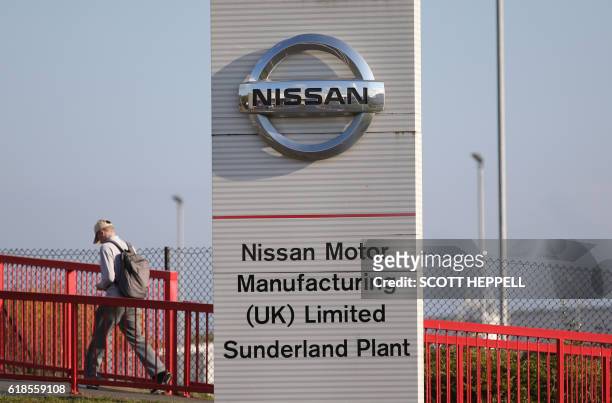 Workers leave the Nissan car plant after finishing their shift in Sunderland, north east England on October 25, 2016. - Japanese car giant Nissan...