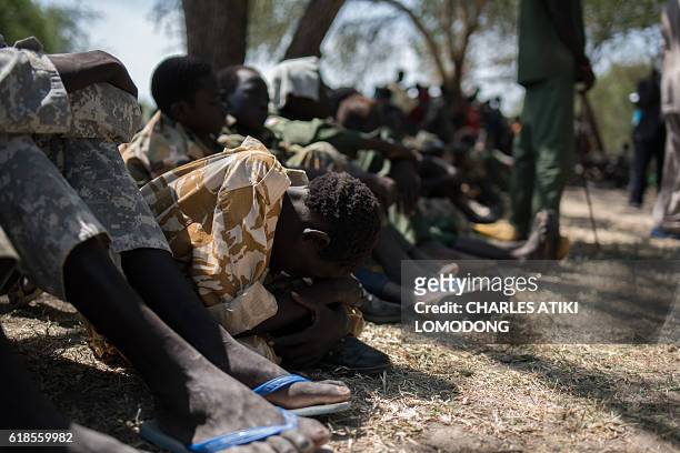 Child soldiers wait after being released from a group called the Cobra Faction and from the main SPLA/IO rebel faction during a ceremony in Tenet,...