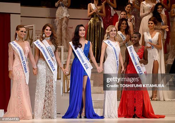 Five contestants pose after having been elected as Miss Five continents during the Miss International beauty pageant final in Tokyo on October 27,...