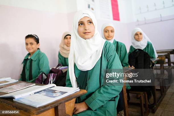 Irbid, Jordan Girls are sitting on school benches during lesson in the Ajnadayn girls school on October 05, 2016 in Irbid, Jordan.