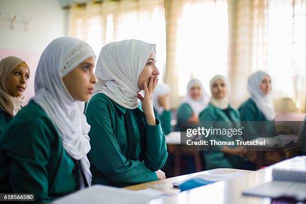 Irbid, Jordan Girls are sitting on school benches during lesson in the Ajnadayn girls school on October 05, 2016 in Irbid, Jordan.