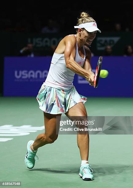 Angelique Kerber of Germany plays a backhand in her singles match against Madison Keys of the United States during day 5 of the BNP Paribas WTA...