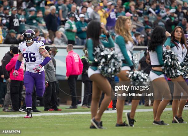 Brian Robison of the Minnesota Vikings runs on the field while the Philadelphia Eagles cheerleaders perform on the field at Lincoln Financial Field...