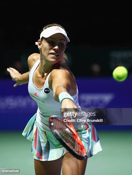 Angelique Kerber of Germany plays a backhand in her singles match against Madison Keys of the United States during day 5 of the BNP Paribas WTA...