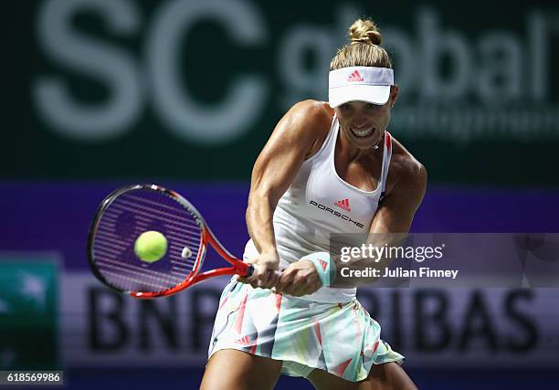 Angelique Kerber of Germany plays a backhand in her singles match against Madison Keys of the United States during day 5 of the BNP Paribas WTA...