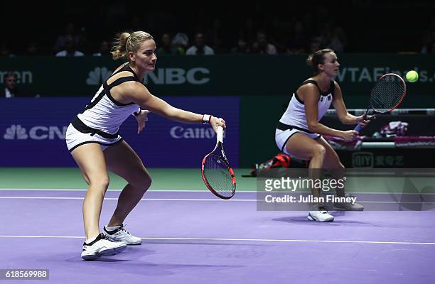 Timea Babos of Hungary and Yaroslava Shvedova of Kazakhstan in action in their doubles match against Bethanie Mattek-Sands of the United States and...