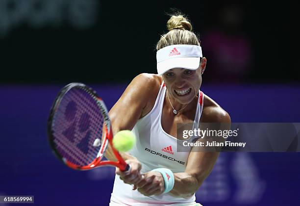 Angelique Kerber of Germany plays a backhand in her singles match against Madison Keys of the United States during day 5 of the BNP Paribas WTA...