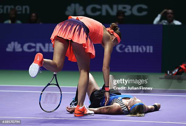 Bethanie Mattek-Sands of the United States goes to ground partnering Lucie Safarova of Czech Republic in their doubles match against Yaroslava...