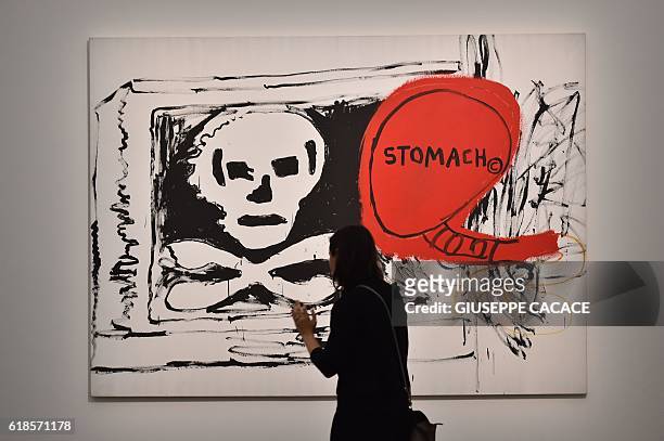 Woman visits the exhibition "Jean-Michel Basquiat", a retrospective on Jean-Michel Basquiats career from graffiti in New York to more complex work,...