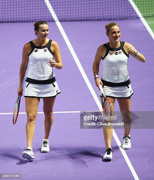 Yaroslava Shvedova of Kazakhstan and Timea Babos of Hungary talk in their doubles match against Bethanie Mattek-Sands of the United States and Lucie...
