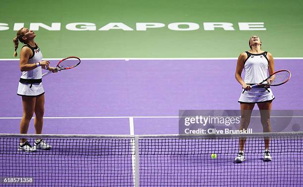 Yaroslava Shvedova of Kazakhstan and Timea Babos of Hungary react in their doubles match against Bethanie Mattek-Sands of the United States and Lucie...