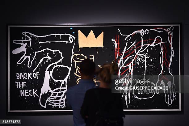 People visit the exhibition "Jean-Michel Basquiat", a retrospective on Jean-Michel Basquiats career from graffiti in New York to more complex work,...